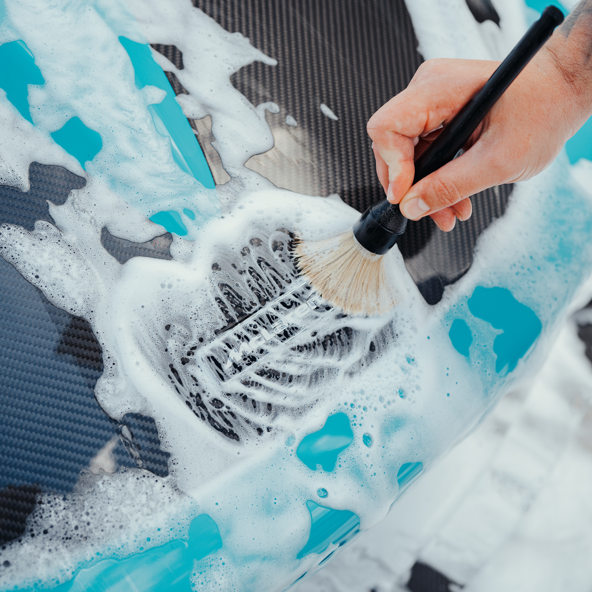 car detailing brushes on exterior of car