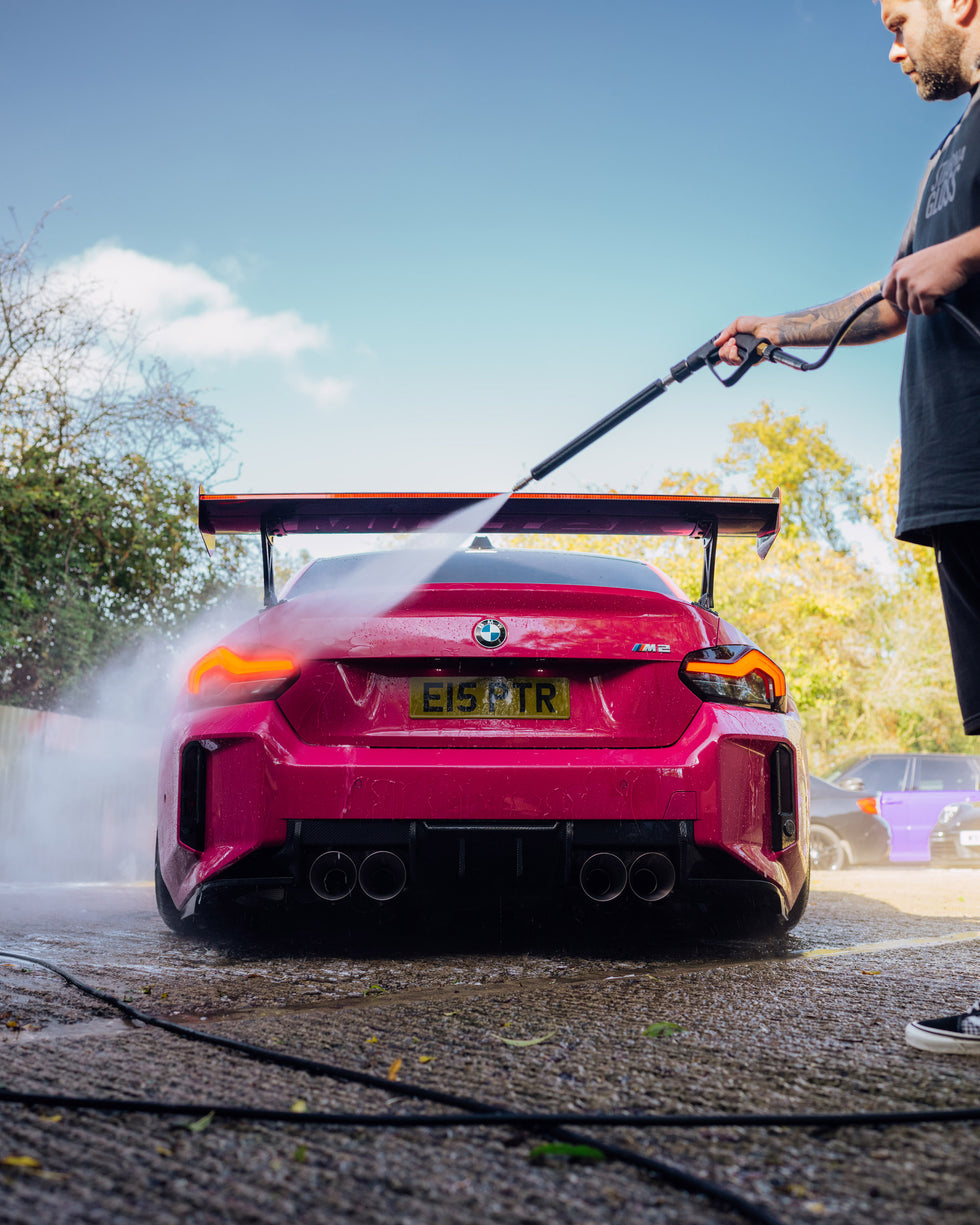 Jet washing back of BMW car