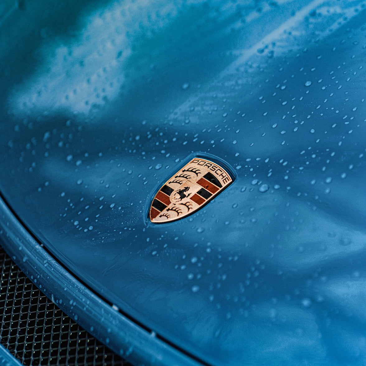 Porsche badge on blue car
